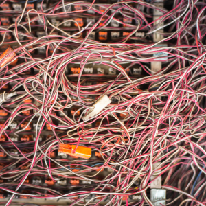 A mess of disorganized cables in reds, oranges, and whites. 